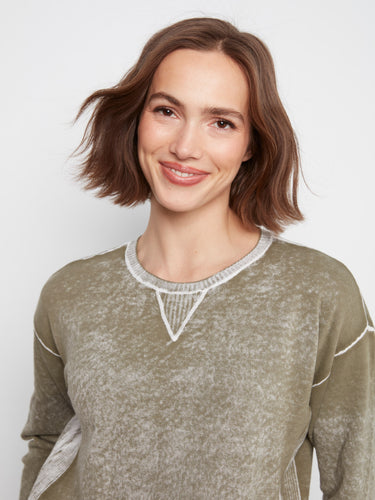 Elegant olive sweater crafted from 100% cotton, highlighted by its unique design details. Created by Charlie B.