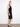 This sleeveless black dress offers comfort with its lined interior and effortless elegance for any event. By Charlie B.