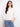 White blouse with a tie at the notched neckline, featuring eyelet detailing and 3/4 sleeves with elastic cuffs by Charlie B.