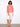 Delicate eyelet detailing enhances the charm of this vibrant coral blouse for a chic look. By Charlie B.