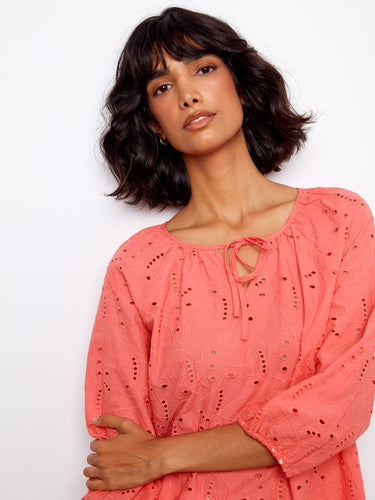 The scalloped hemline gives this coral top an elegant finish, perfect for casual and dressy occasions. By Charlie B.