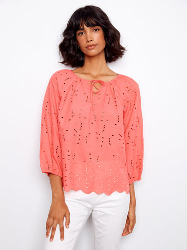 Enjoy the comfort and style of 3/4 sleeves in this beautifully designed coral blouse. By Charlie B.