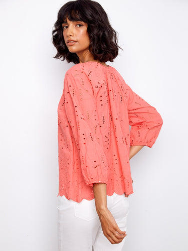 Elastic cuffs provide a snug fit on the sleeves of this stylish and comfortable coral top. By Charlie B.
