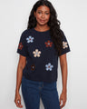 Navy top with a crew neck and floral design, made from soft 100% cotton for comfort. By Charlie B.