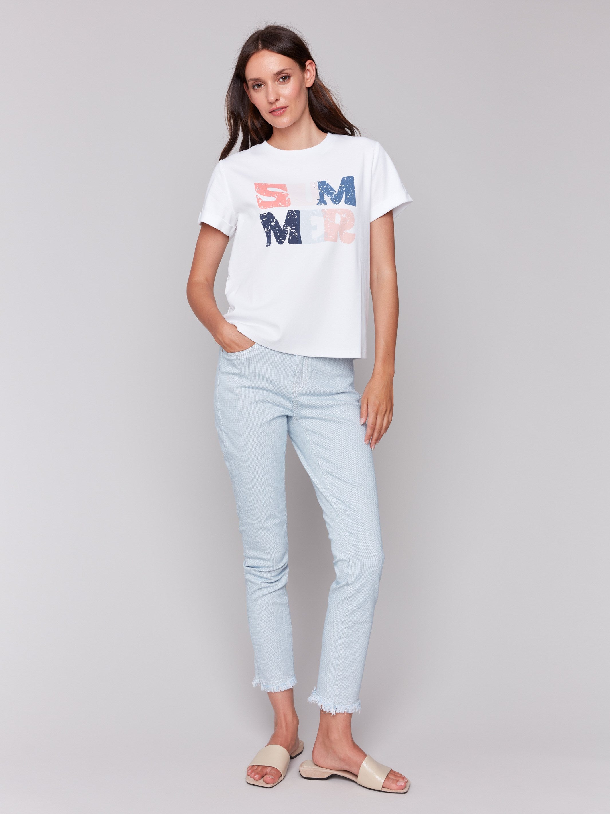 Crew neckline on a white t-shirt featuring bold graphic design by Charlie B.