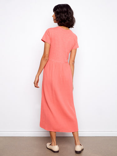 The coral dress is tailored to midi length, perfect for versatile styling. Made from soft 100% cotton by Charlie B.