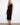 Black dress with a classic crew neck and elegant design, crafted from 100% cotton for comfort and style by Charlie B.