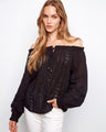 Black blouse with semi-sheer cotton fabric and lace-up front, featuring elastic cuffs by Charlie B.