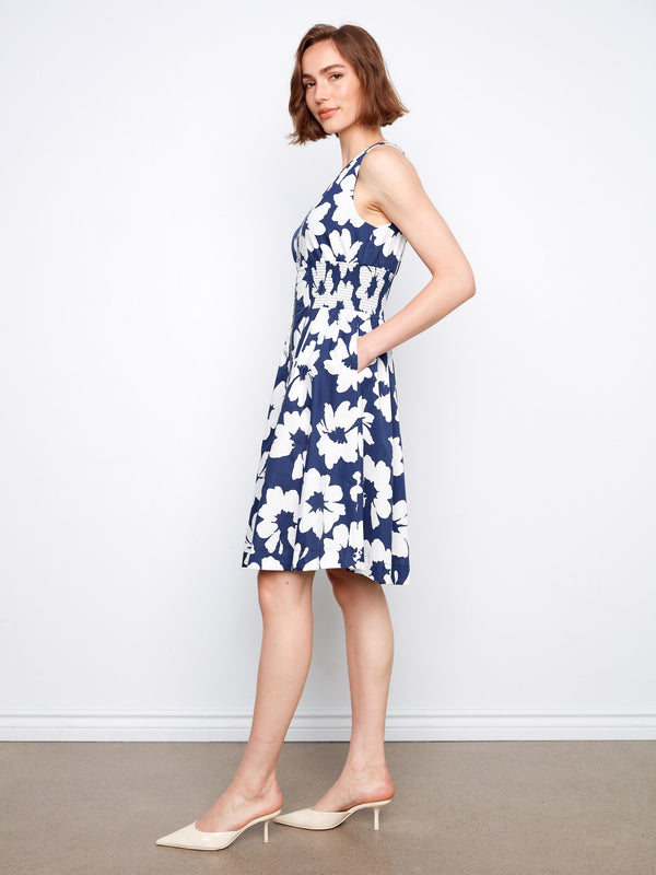 Stylish knee-length floral dress with hidden pockets, offering both elegance and functionality for everyday wear by Charlie B.