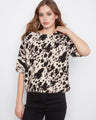 Chic top with a mock neck, featuring a stylish animal print pattern and soft brushed knit fabric for ultimate comfort by Charlie B.