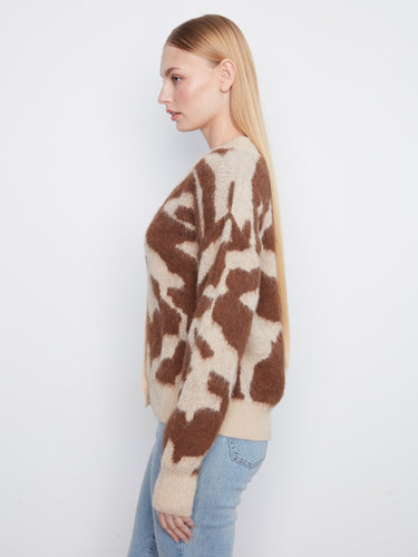Fuzzy knit texture provides warmth and comfort in this trendy cardigan. By Charlie B.