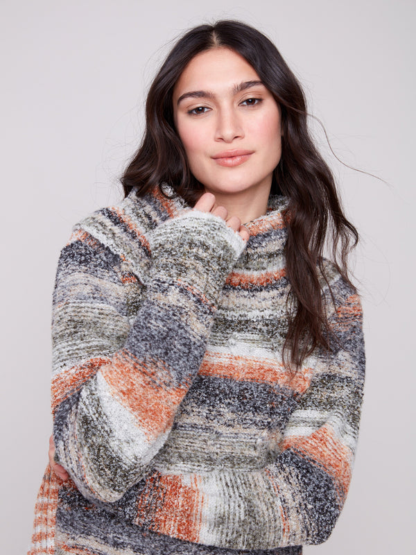 Cable knit sweater in rich autumn colors, offering warmth and style for the season by Charlie B.