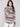 Sweater with cable knit detailing and a flattering round hem in earthy tones for fall fashion by Charlie B.