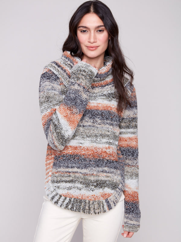 Sweater with cable knit detailing and a flattering round hem in earthy tones for fall fashion by Charlie B.