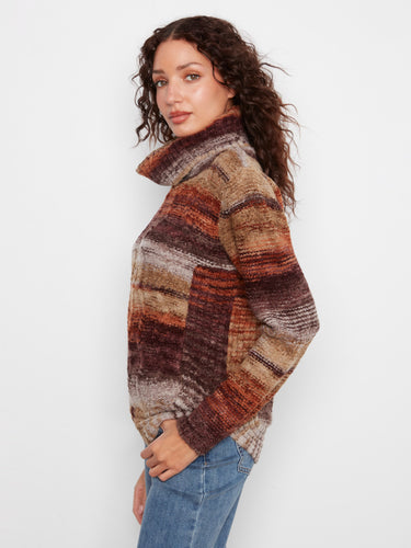 Stylish cable knit sweater with bold stripes and ribbed cuffs, complementing the relaxed fit of the design by Charlie B.