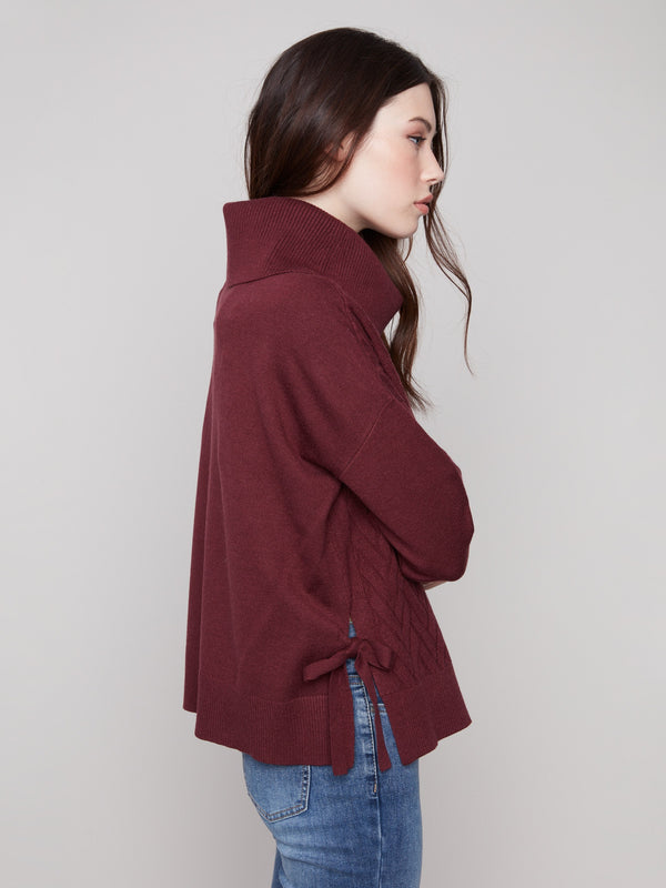 Elegant cabernet sweater with drop shoulders and chevron pattern for a relaxed yet chic look. By Charlie B.