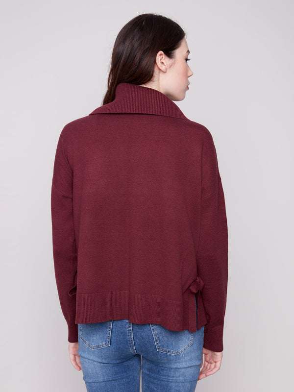 Chic cabernet sweater showcasing drop shoulders and ribbed cuffs, ideal for effortless style. By Charlie B.