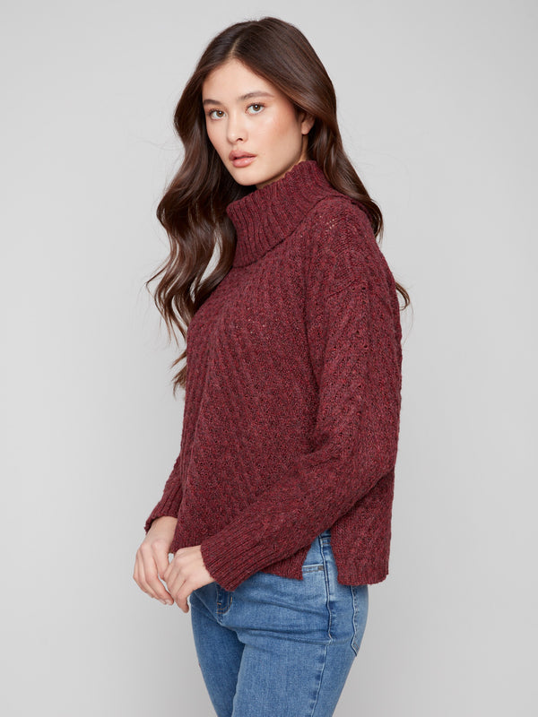 Chic cabernet sweater with slit hem detailing, adding flair to the classic cable knit style by Charlie B.