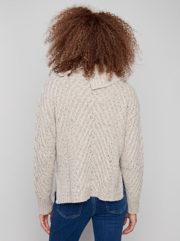 Cozy cowl neck design in Heather Oat color with intricate knitting details by Charlie B.