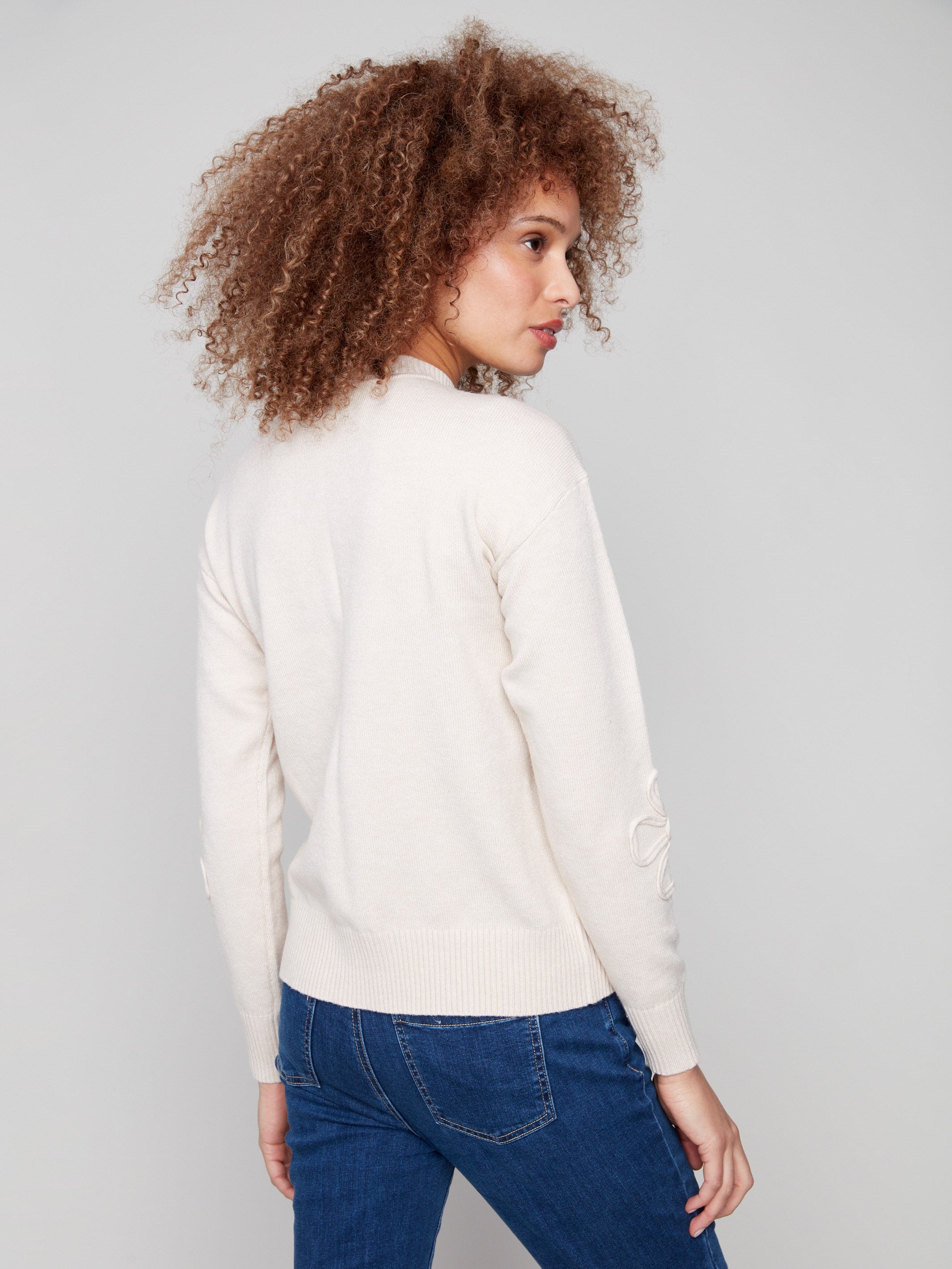 Elegant Heather Oat sweater showcasing ribbed cuffs and hem for a polished, finished look by Charlie B.