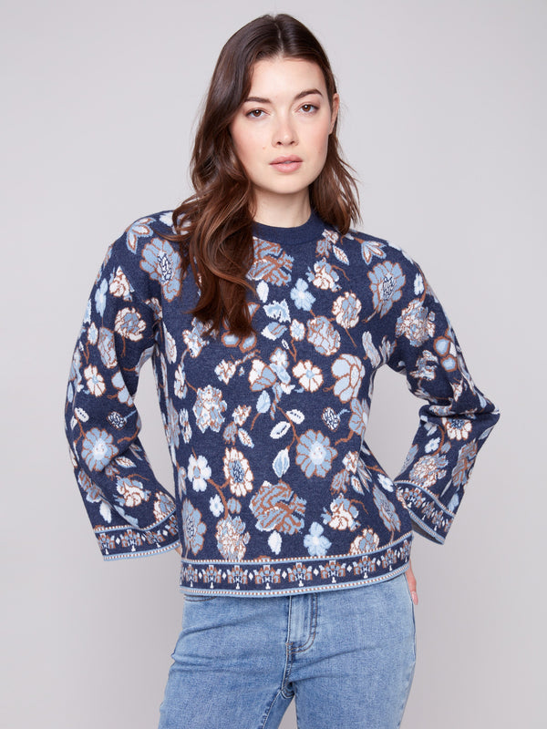 Navy blue sweater with dolman sleeves, featuring a floral jacquard pattern for a stylish look by Charlie B.
