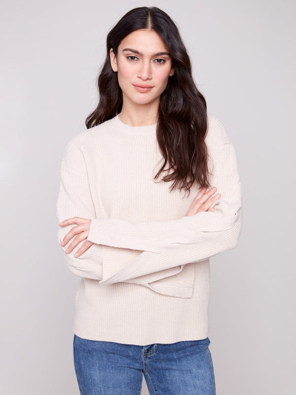 Oat sweater showcasing drop shoulders and elegant design by Charlie B.