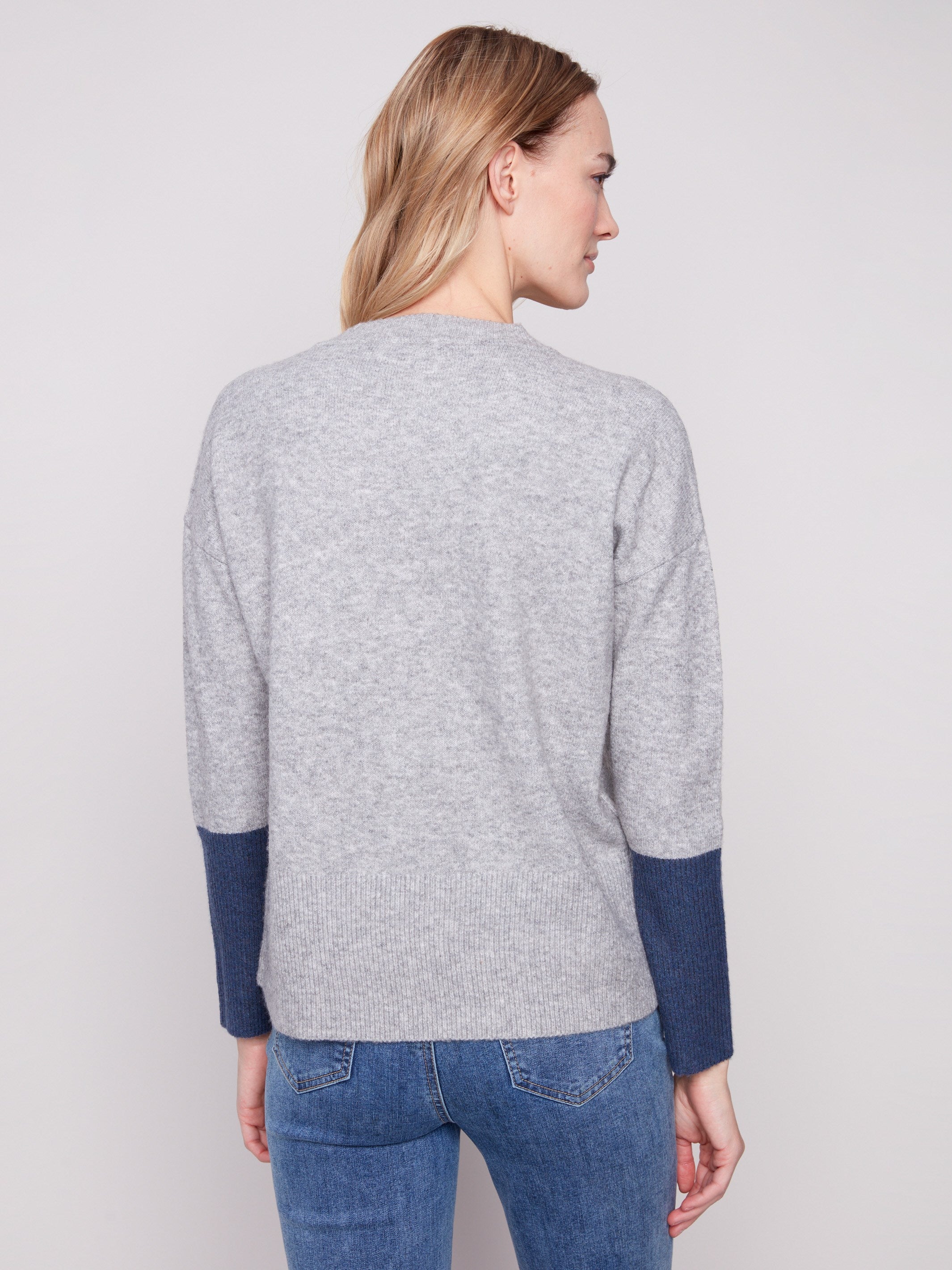 The contrast ribbed sleeve cuffs bring a stylish touch to this heather grey sweater with navy accents by Charlie B.