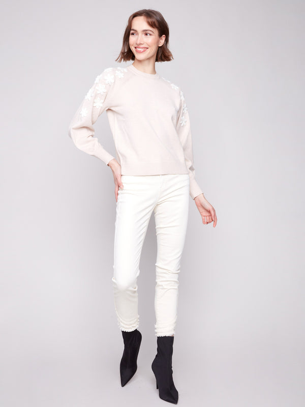 Chic raglan puff sleeves enhance the heather oat sweater adorned with white floral details by Charlie B.