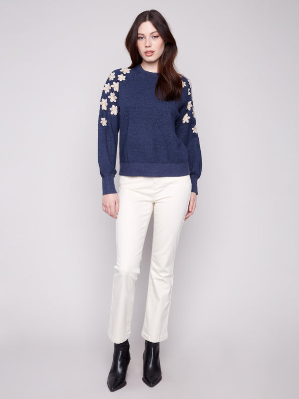 Heather denim sweater with elegant raglan puff sleeves and detailed white floral embroidery on the shoulders for added charm by Charlie B.