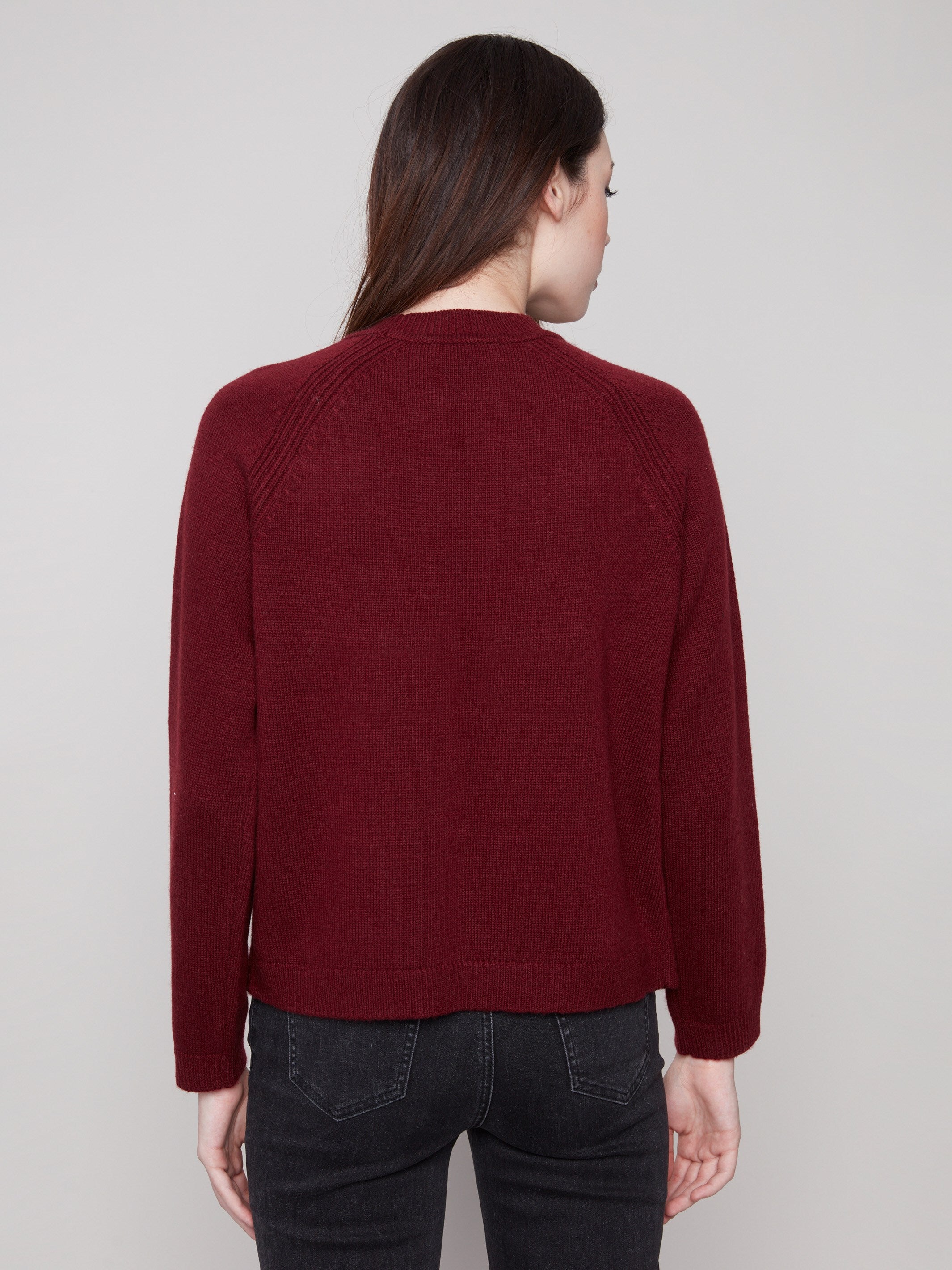 Sophisticated cabernet sweater with faux leather detail at the armhole, adding a modern touch by Charlie B.