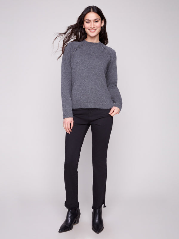 This charcoal sweater showcases raglan sleeves, offering comfort and style. A must-have versatile piece by Charlie B.