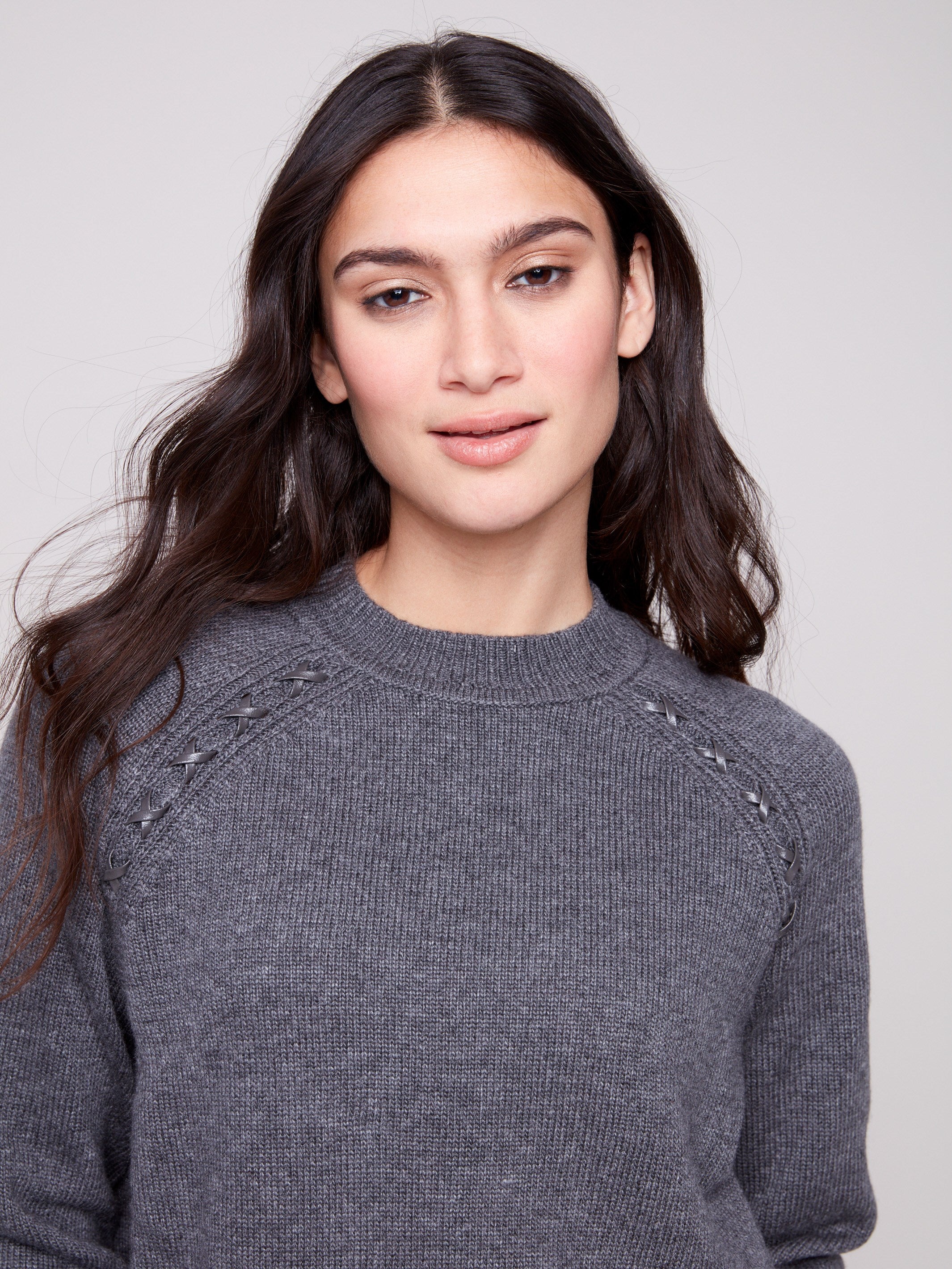 The faux leather detail on this charcoal sweater adds a touch of sophistication and modernity to your wardrobe by Charlie B.