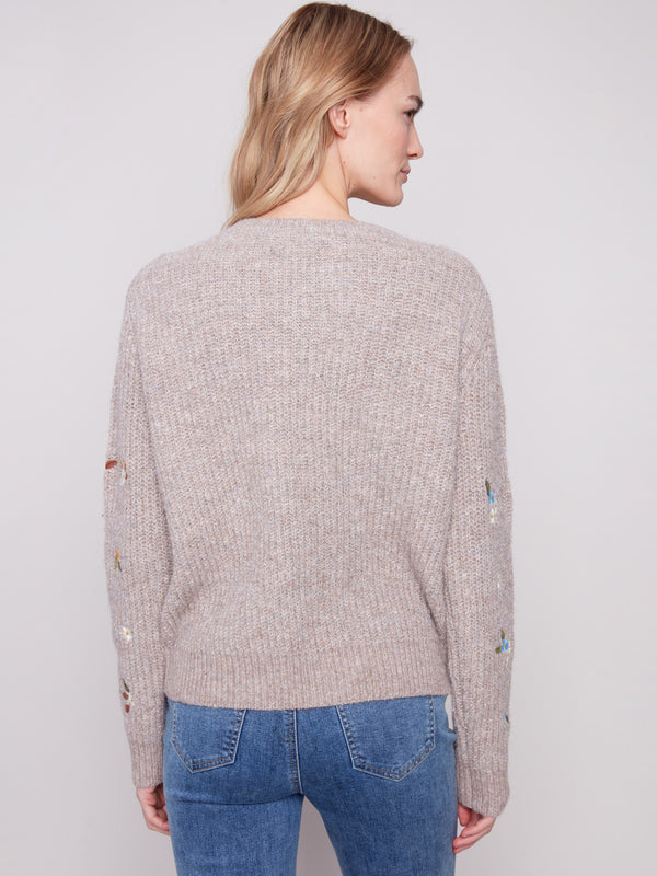 Elegant light brown sweater crafted with exquisite floral embroidery and soft long sleeves for added warmth by Charlie B.