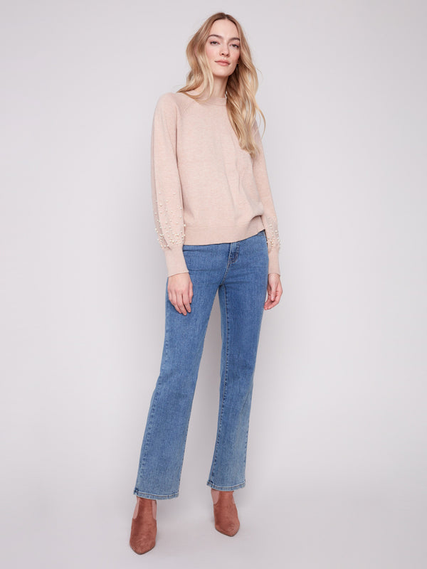 Cozy and fashionable, this crew neck sweater is ideal for layering in cooler weather by Charlie B.