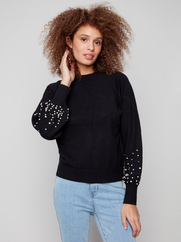 Elegant black sweater with a classic crew neck, featuring exquisite pearl accents on the sleeves by Charlie B.