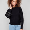 Elegant black sweater with a classic crew neck, featuring exquisite pearl accents on the sleeves by Charlie B.