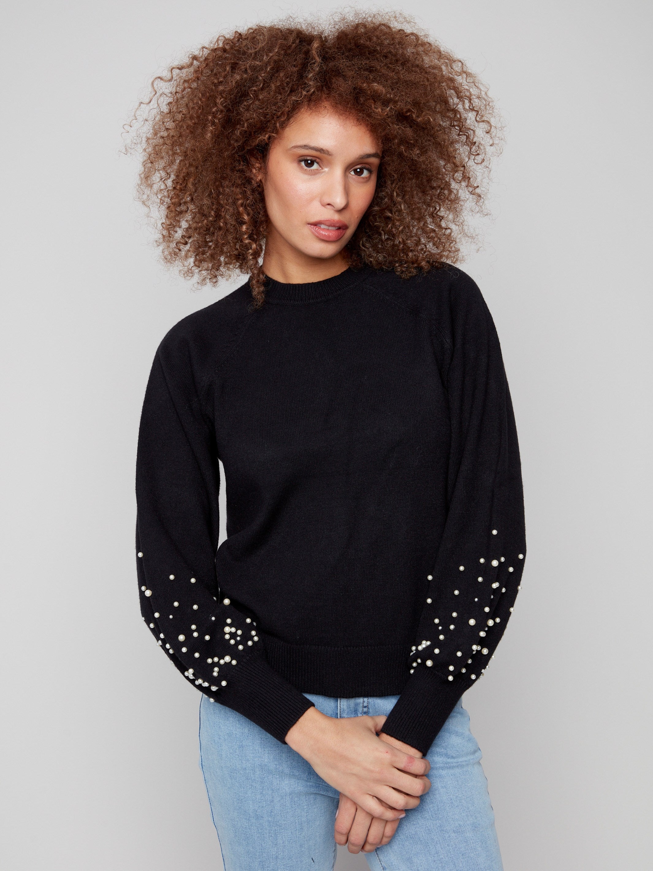 Chic black sweater adorned with stunning pearl details on its statement puff sleeves for a fashionable look by Charlie B.