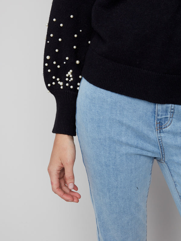 Trendy and timeless, this black sweater features luxurious pearls embellishing its unique puffed sleeves by Charlie B.
