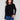 Elegant black sweater with star embellishments, highlighting the crew neck design for versatile styling by Charlie B.