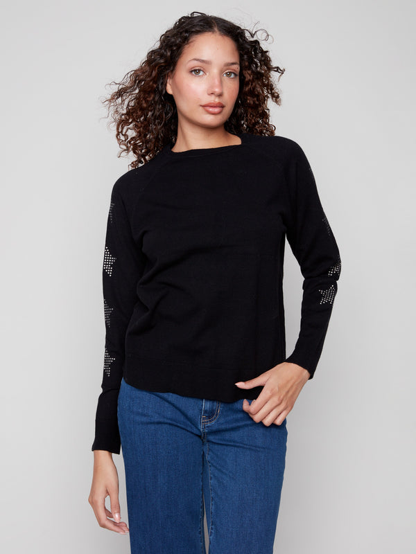 Elegant black sweater with star embellishments, highlighting the crew neck design for versatile styling by Charlie B.