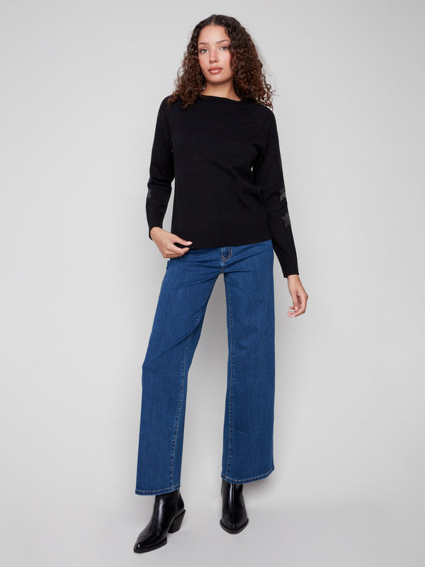 Chic black sweater featuring a classic crew neck and eye-catching star details on the sleeves by Charlie B.