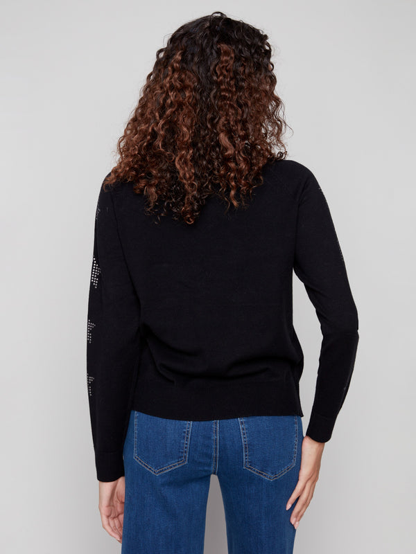 Trendy black sweater with intricate star patterns on sleeves, enhanced by its sleek crew neckline by Charlie B.