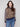 Sweater featuring drop shoulders with a bold leopard print and striped sleeves by Charlie B.