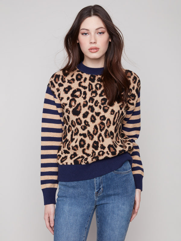 Sweater featuring drop shoulders with a bold leopard print and striped sleeves by Charlie B.