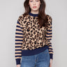 Sweater featuring drop shoulders with a bold leopard print and striped sleeves by Charlie B.