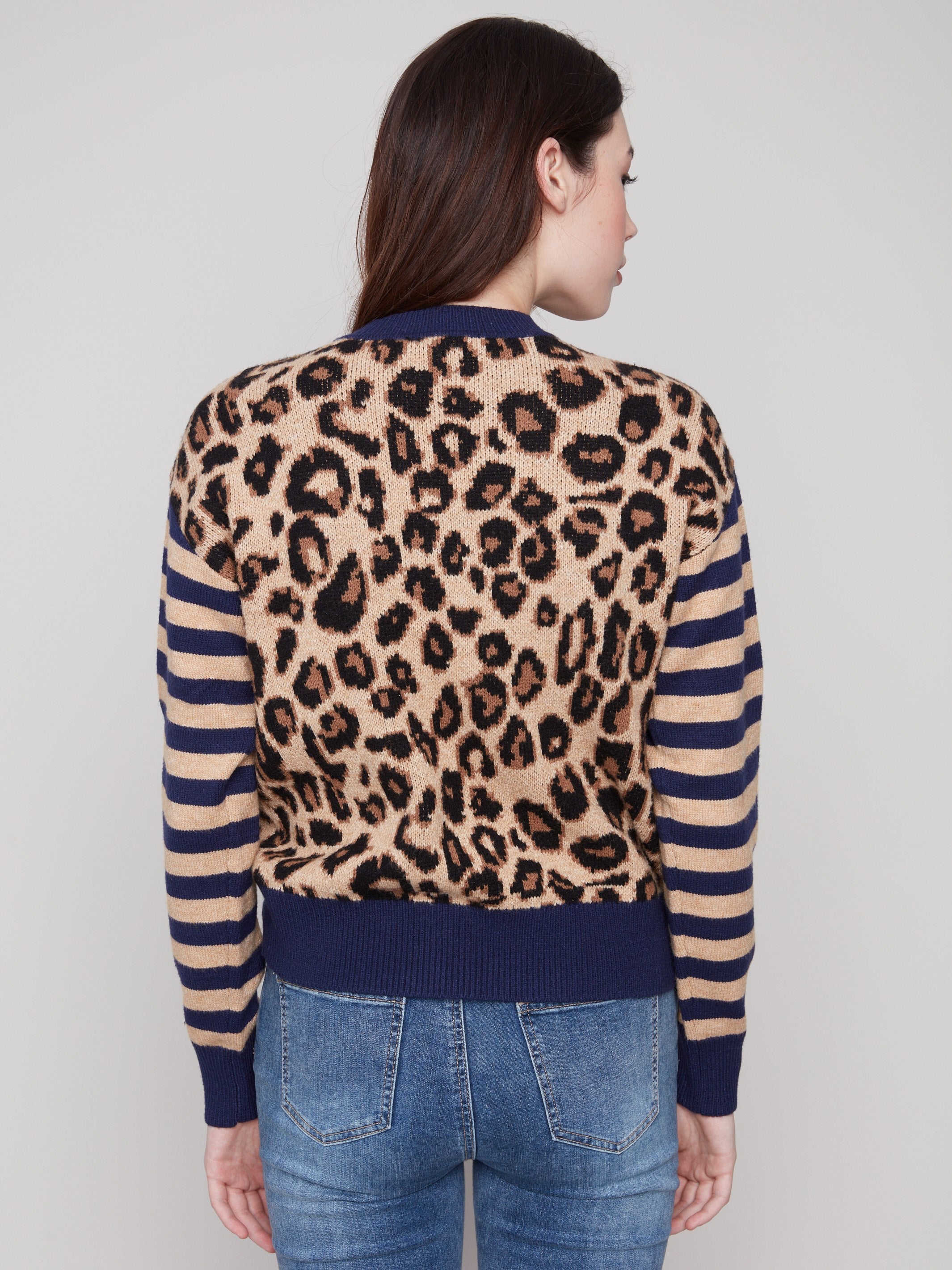 Leopard print sweater showcasing drop shoulders and contrasting striped sleeves by Charlie B.