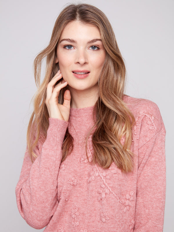 Heathered primrose top showcasing a relaxed fit with drop shoulders and delicate floral details by Charlie B.