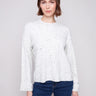 White sweater featuring a drop shoulder design and speckled pattern, ideal for casual wear by Charlie B.