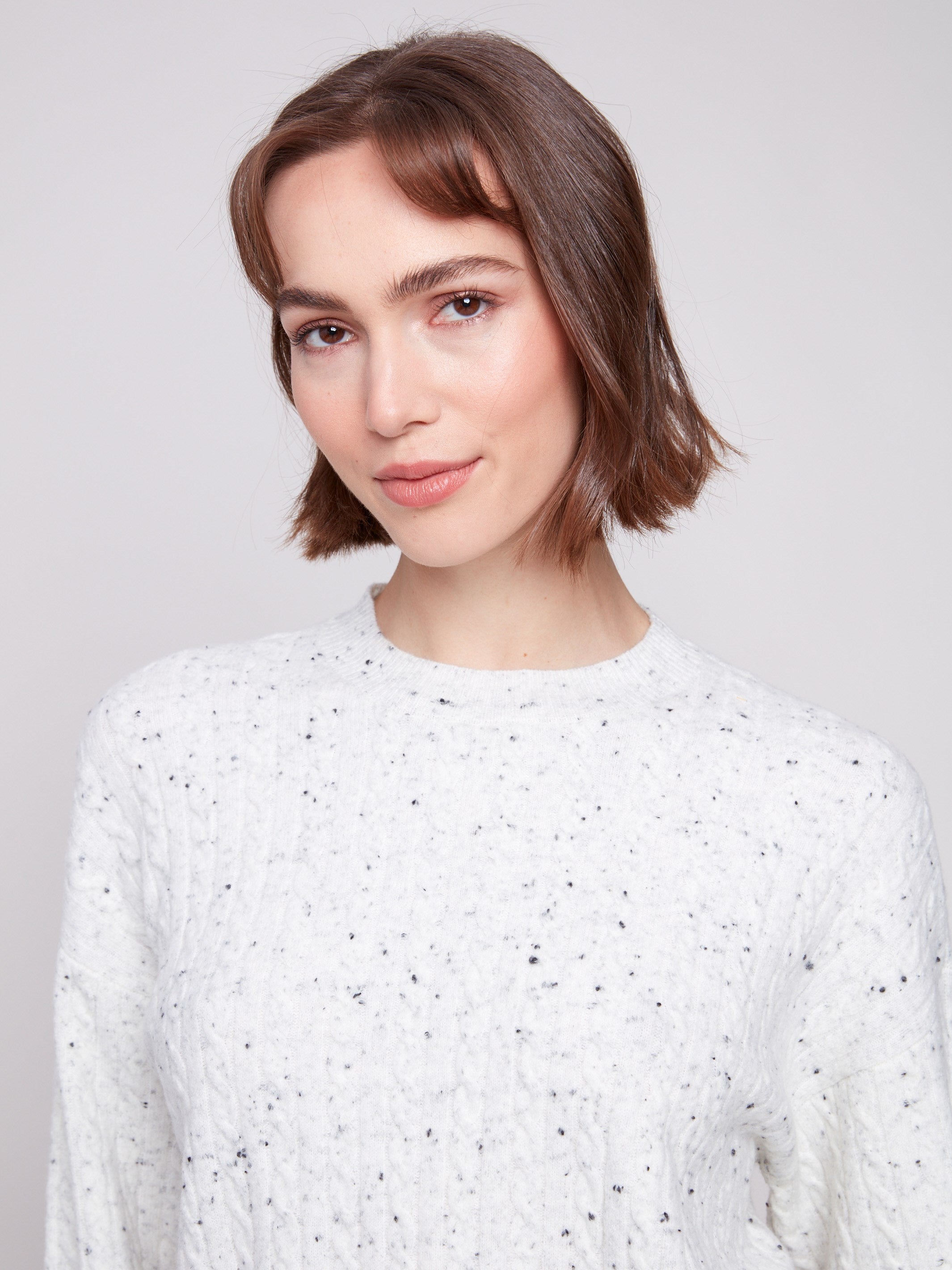 Elegant white sweater with wide cuffs and a unique texture, adding sophistication to any outfit by Charlie B.