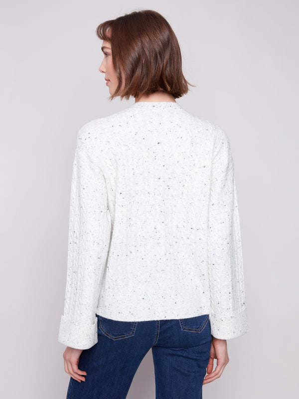 Chic white sweater showcasing wide cuffs and a relaxed fit, enhancing your wardrobe essentials by Charlie B.